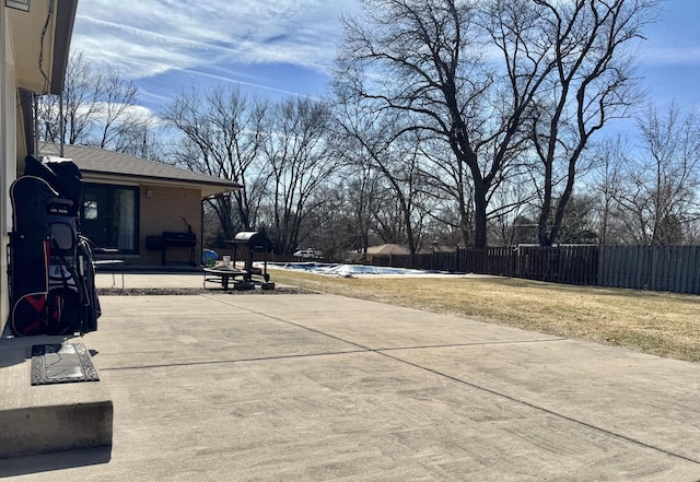 view of patio with grilling area, an outdoor fire pit, and fence