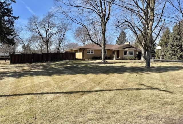 view of yard with fence and driveway