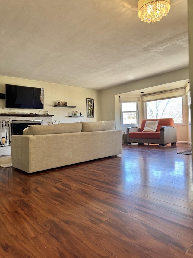 unfurnished living room with dark wood-type flooring and a chandelier