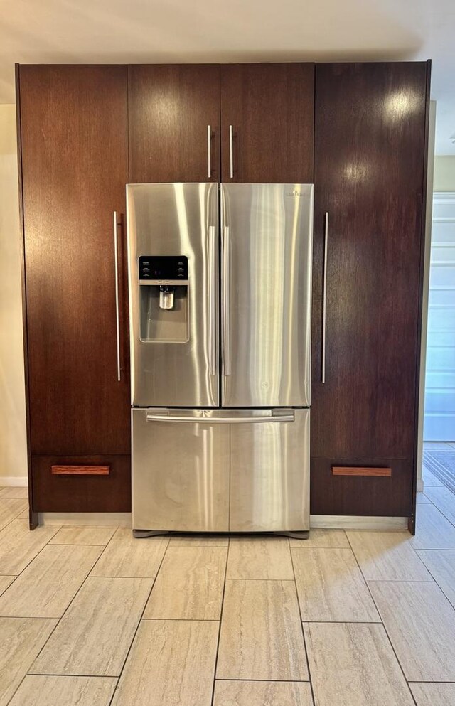 kitchen featuring dark brown cabinets and stainless steel refrigerator with ice dispenser