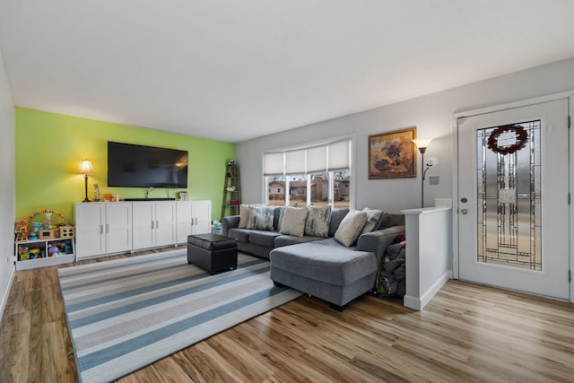 living room featuring wood finished floors and baseboards