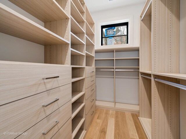 2832 N Racine Ave Unit 1E, Chicago, IL 60657 - unfurnished bedroom featuring multiple closets, light wood-type flooring, ornamental molding, and baseboards
