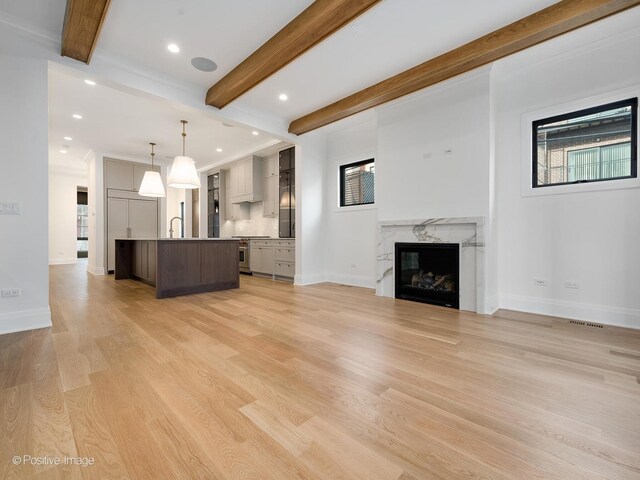 2832 N Racine Ave Unit 1E, Chicago, IL 60657 - kitchen with a sink, light wood-type flooring, decorative backsplash, light stone countertops, and beam ceiling