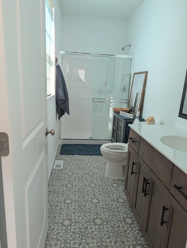 full bath featuring visible vents, a stall shower, toilet, and vanity