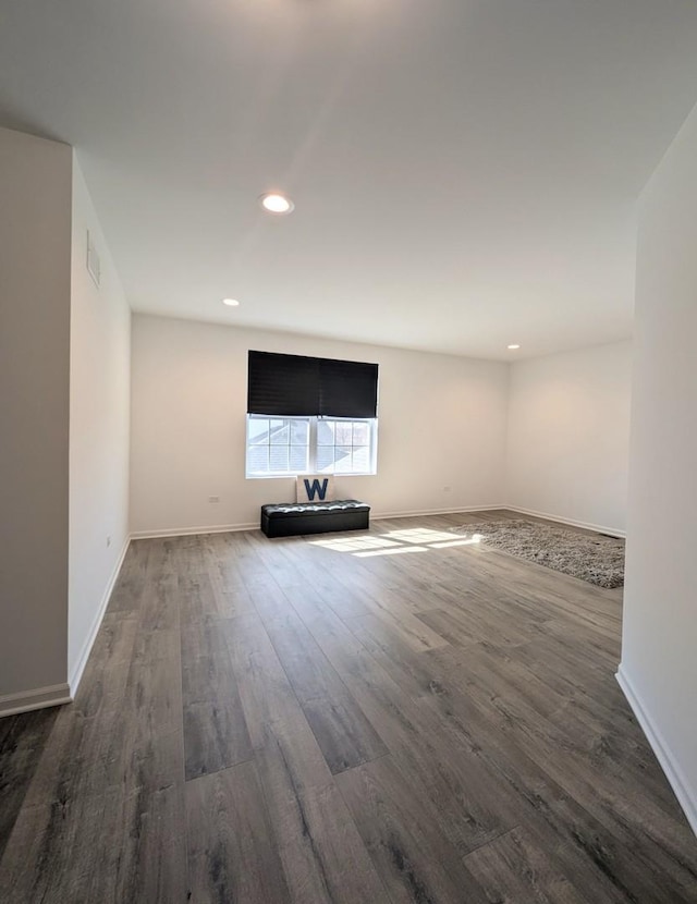 unfurnished living room featuring visible vents, recessed lighting, baseboards, and wood finished floors