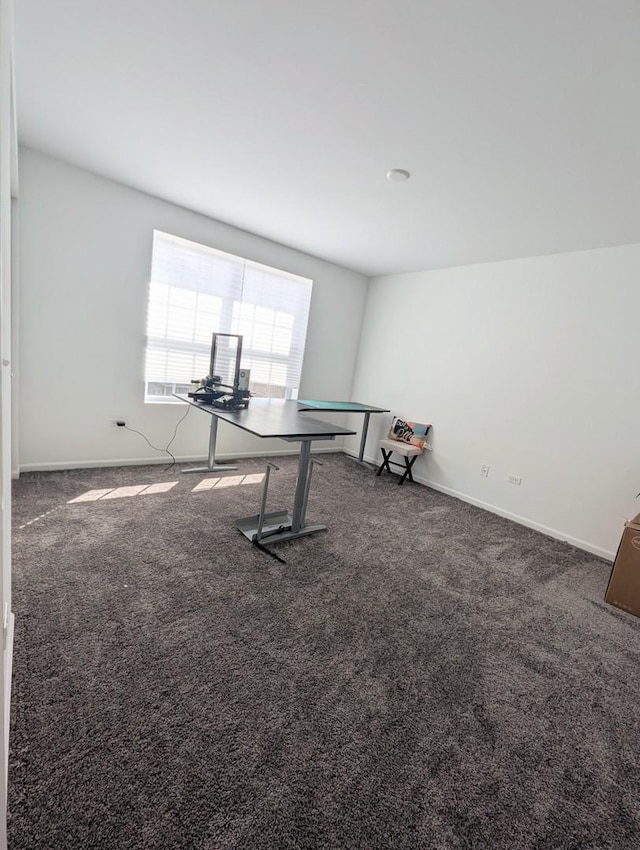 unfurnished room featuring baseboards and carpet floors