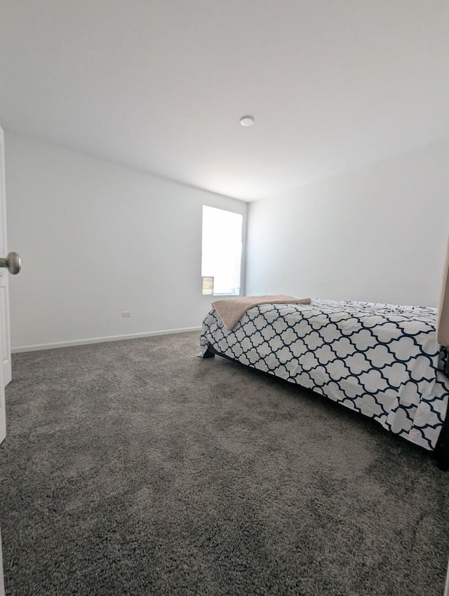 unfurnished bedroom featuring baseboards and carpet floors