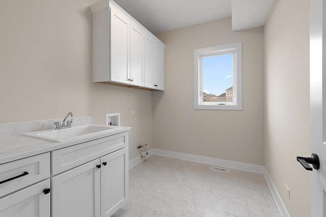 clothes washing area with washer hookup, marble finish floor, cabinet space, visible vents, and a sink