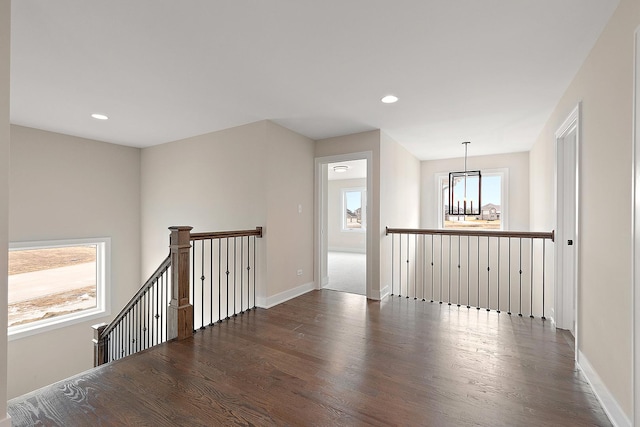 spare room with recessed lighting, dark wood-style flooring, and baseboards