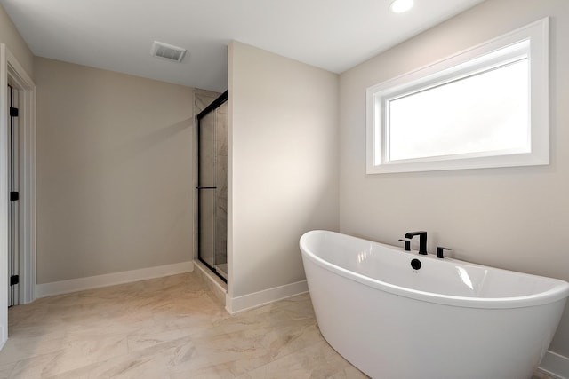 bathroom with a freestanding tub, visible vents, baseboards, marble finish floor, and a stall shower