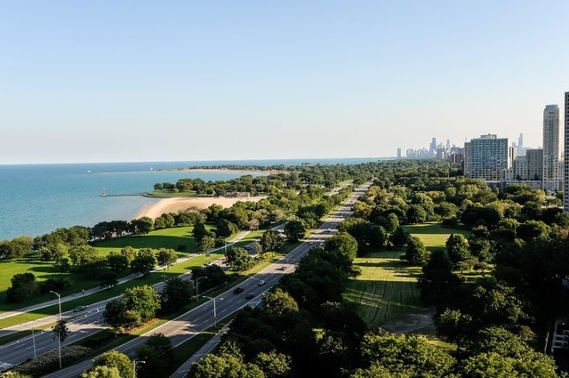 birds eye view of property with a water view and a view of city