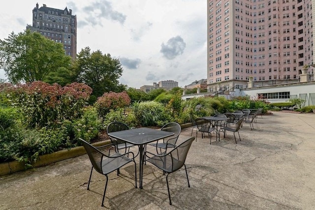 view of patio / terrace with a view of city and outdoor dining area