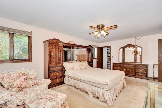 bedroom featuring a ceiling fan and light colored carpet