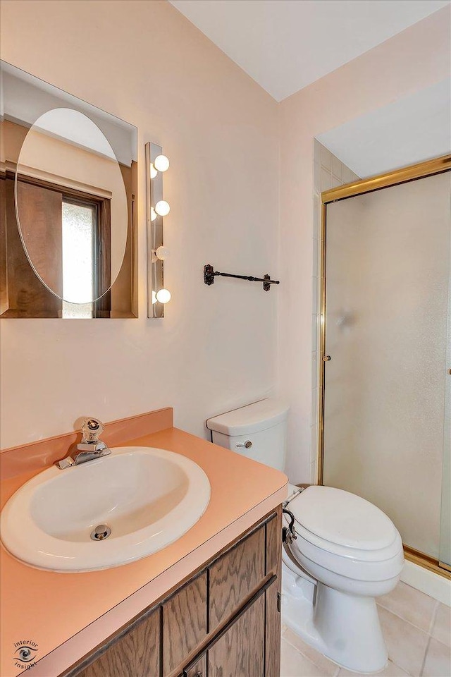 bathroom with toilet, a stall shower, tile patterned floors, and vanity