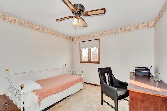 bedroom featuring baseboards, a ceiling fan, and light colored carpet