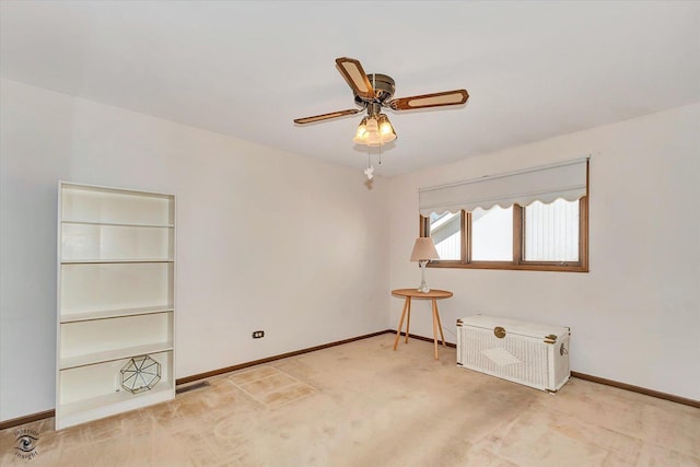 empty room featuring light carpet, visible vents, baseboards, and a ceiling fan