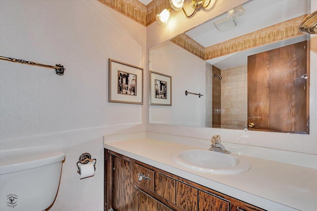 full bathroom featuring toilet, a shower, and vanity