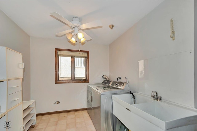 laundry area with light floors, washing machine and clothes dryer, a sink, laundry area, and baseboards