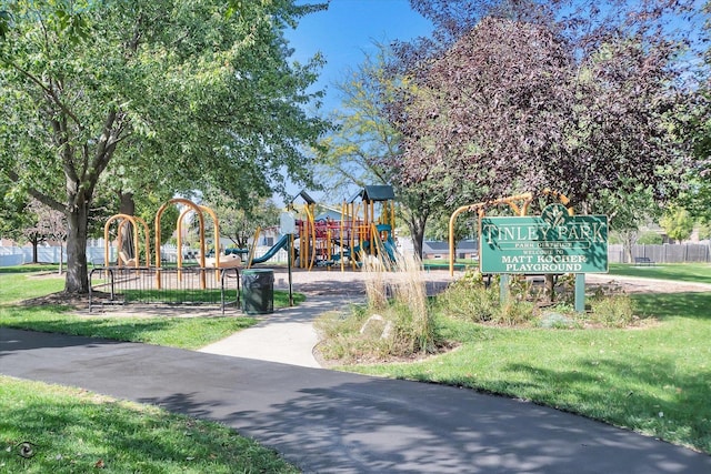 community play area featuring fence and a yard