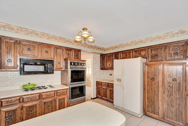 kitchen with light tile patterned floors, wallpapered walls, brown cabinets, light countertops, and black appliances