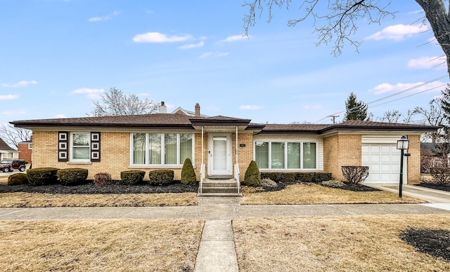 single story home with brick siding, driveway, a chimney, and an attached garage