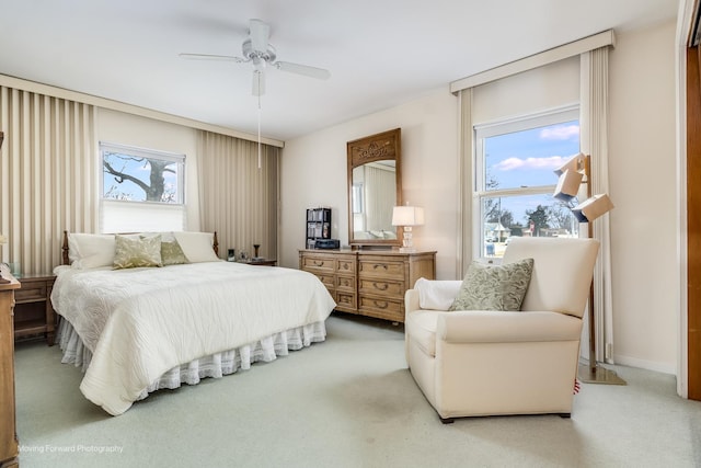 bedroom with baseboards, a ceiling fan, and light colored carpet