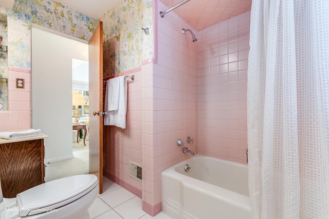 bathroom with wallpapered walls, wainscoting, tile walls, and tile patterned floors