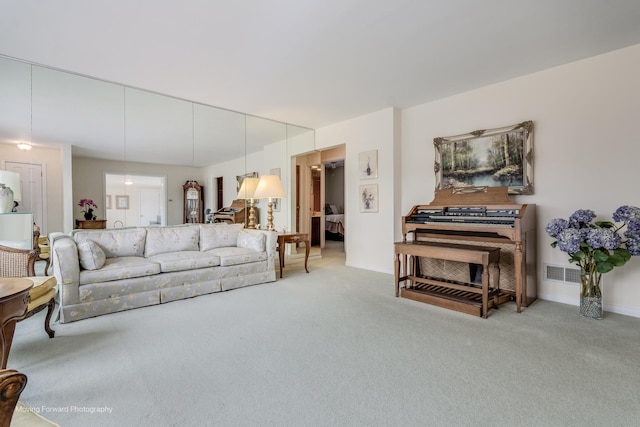 carpeted living room with baseboards and visible vents