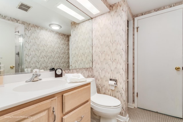 bathroom featuring toilet, visible vents, a shower stall, tile patterned floors, and wallpapered walls