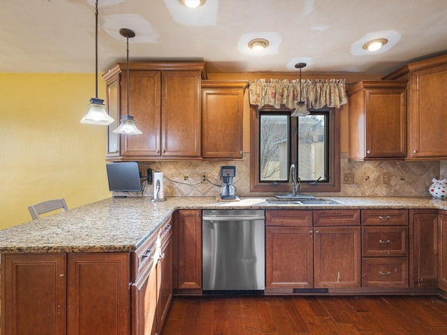 kitchen with a peninsula, dark wood-style flooring, a sink, stainless steel dishwasher, and brown cabinets