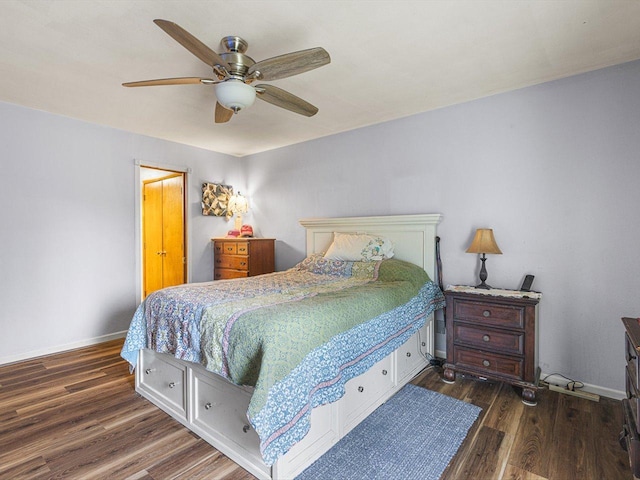 bedroom featuring ceiling fan, baseboards, and wood finished floors