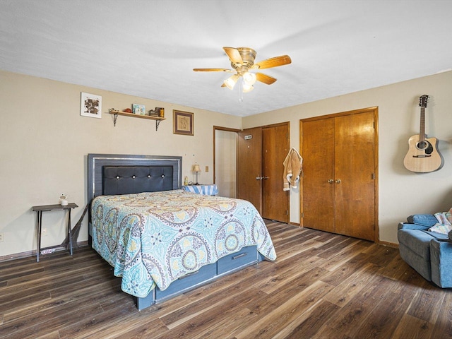 bedroom with ceiling fan, baseboards, multiple closets, and wood finished floors