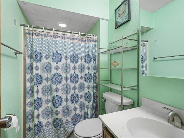 bathroom featuring a shower with shower curtain, toilet, and vanity