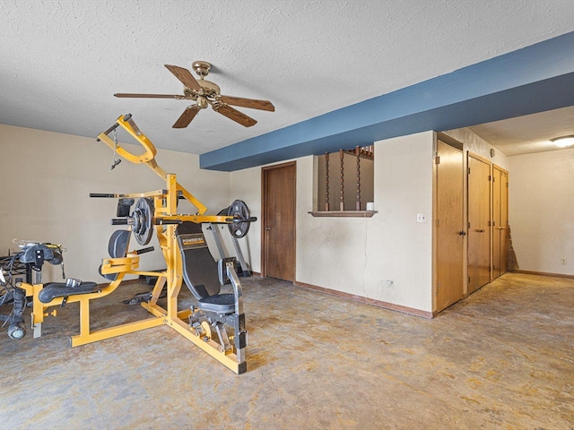 exercise room with ceiling fan, baseboards, and a textured ceiling