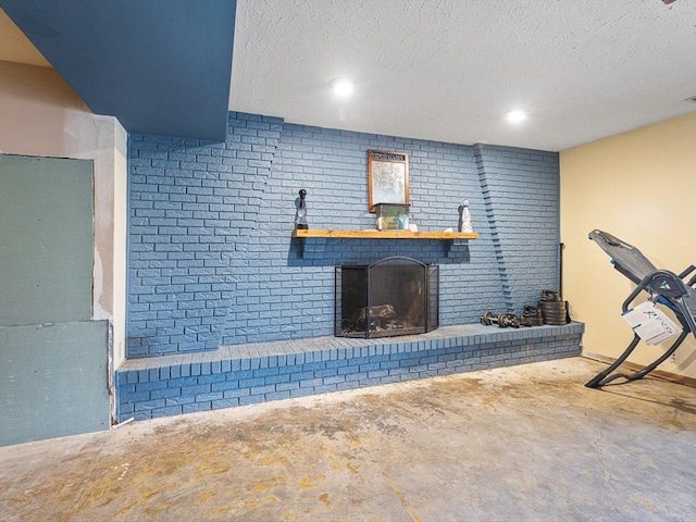 exercise area with a fireplace and a textured ceiling