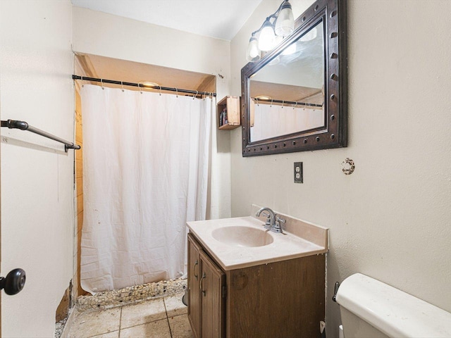 bathroom with a shower with curtain, toilet, vanity, and tile patterned flooring