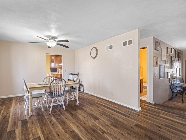 dining area with visible vents, baseboards, and wood finished floors