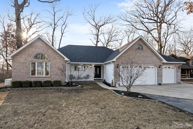 ranch-style home featuring covered porch, concrete driveway, a front lawn, a garage, and brick siding