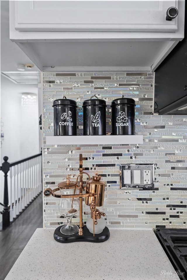 details featuring light stone counters and tasteful backsplash