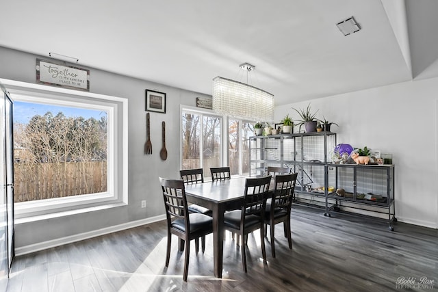 dining room featuring wood finished floors and baseboards