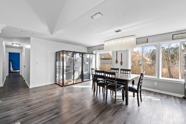 dining room with baseboards and dark wood-style flooring