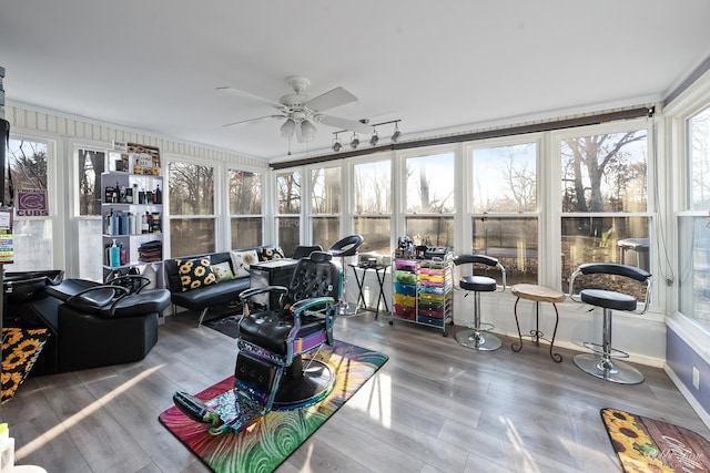 sunroom featuring a ceiling fan