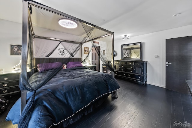 bedroom featuring wood finished floors and baseboards