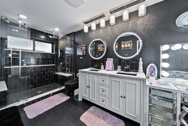 full bath with a sink, toilet, a shower stall, and double vanity