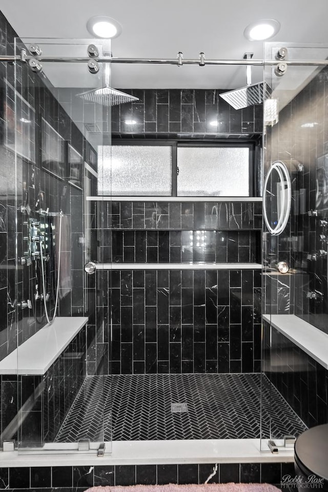 bathroom with a stall shower and toilet