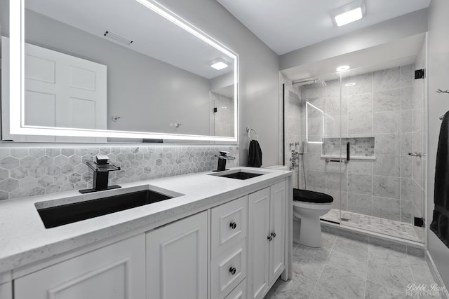 full bathroom featuring a stall shower, toilet, tasteful backsplash, and a sink