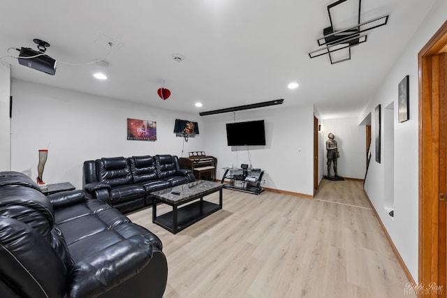 living room with recessed lighting, baseboards, and light wood-style floors