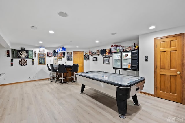 playroom with a dry bar, recessed lighting, light wood-style flooring, and baseboards