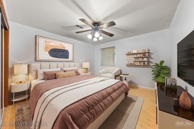 bedroom with visible vents, ceiling fan, light wood-type flooring, and baseboards