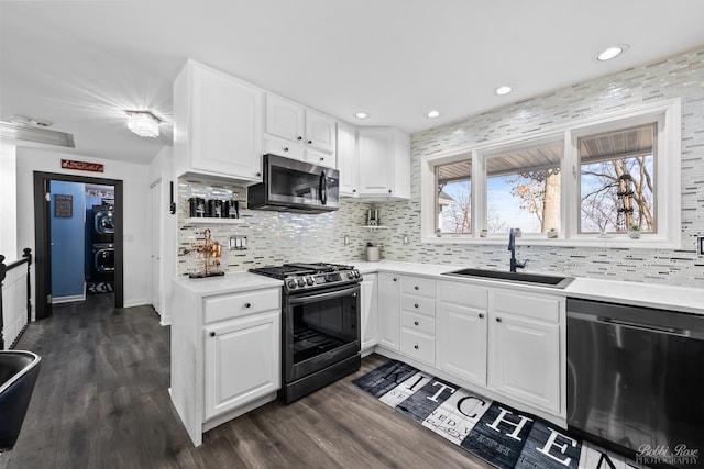 kitchen featuring light countertops, dark wood-style flooring, appliances with stainless steel finishes, and a sink